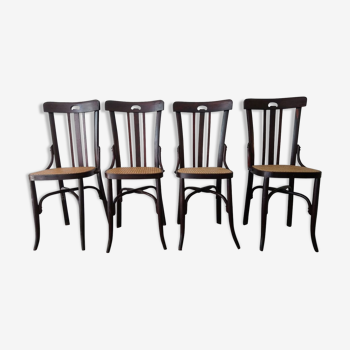 Suite de 4 chaises vintage de bistrot cannées en bois foncé