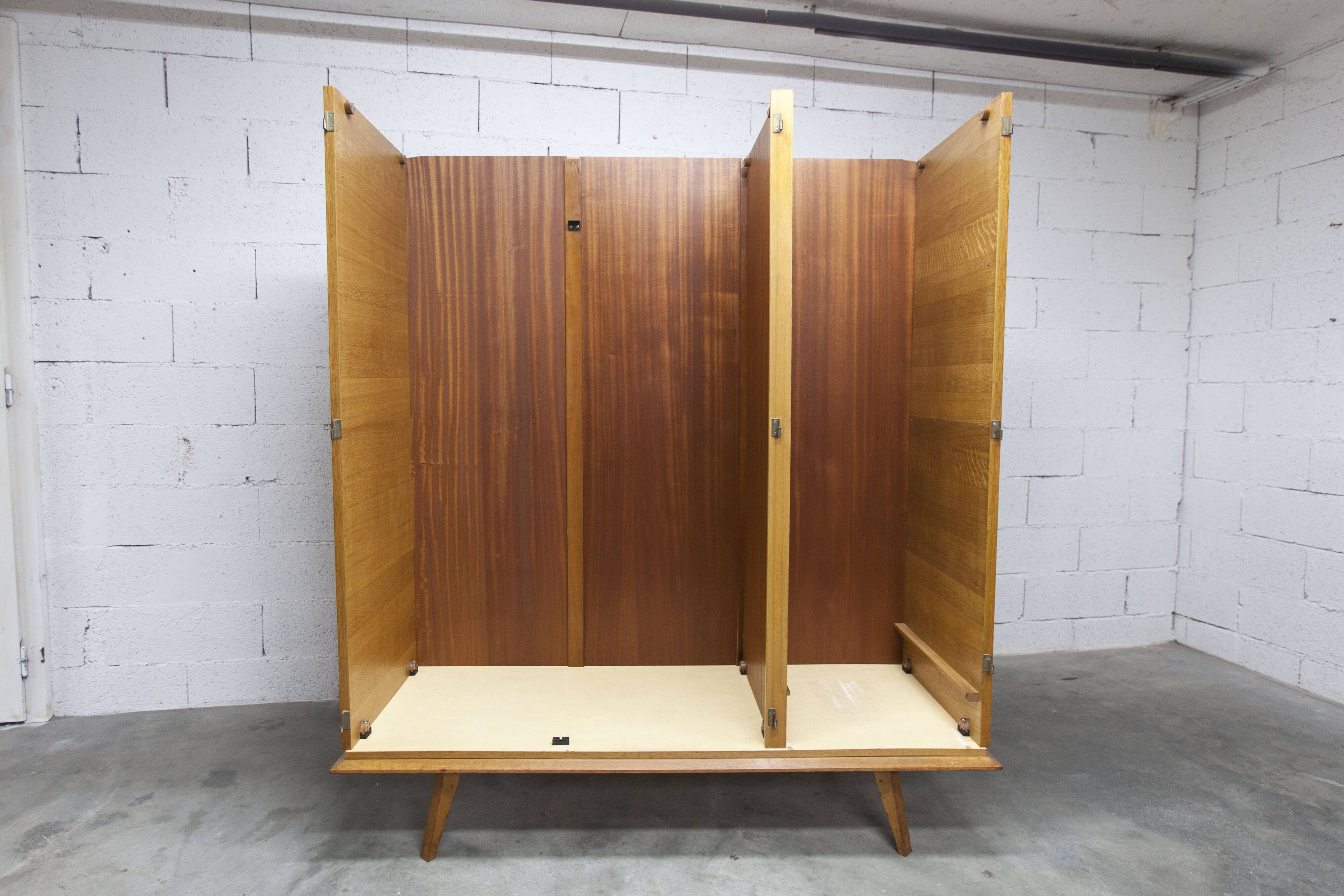 French wardrobe with tapered legs, 3 doors, 1 mirror (27*130), and 1 drawer.