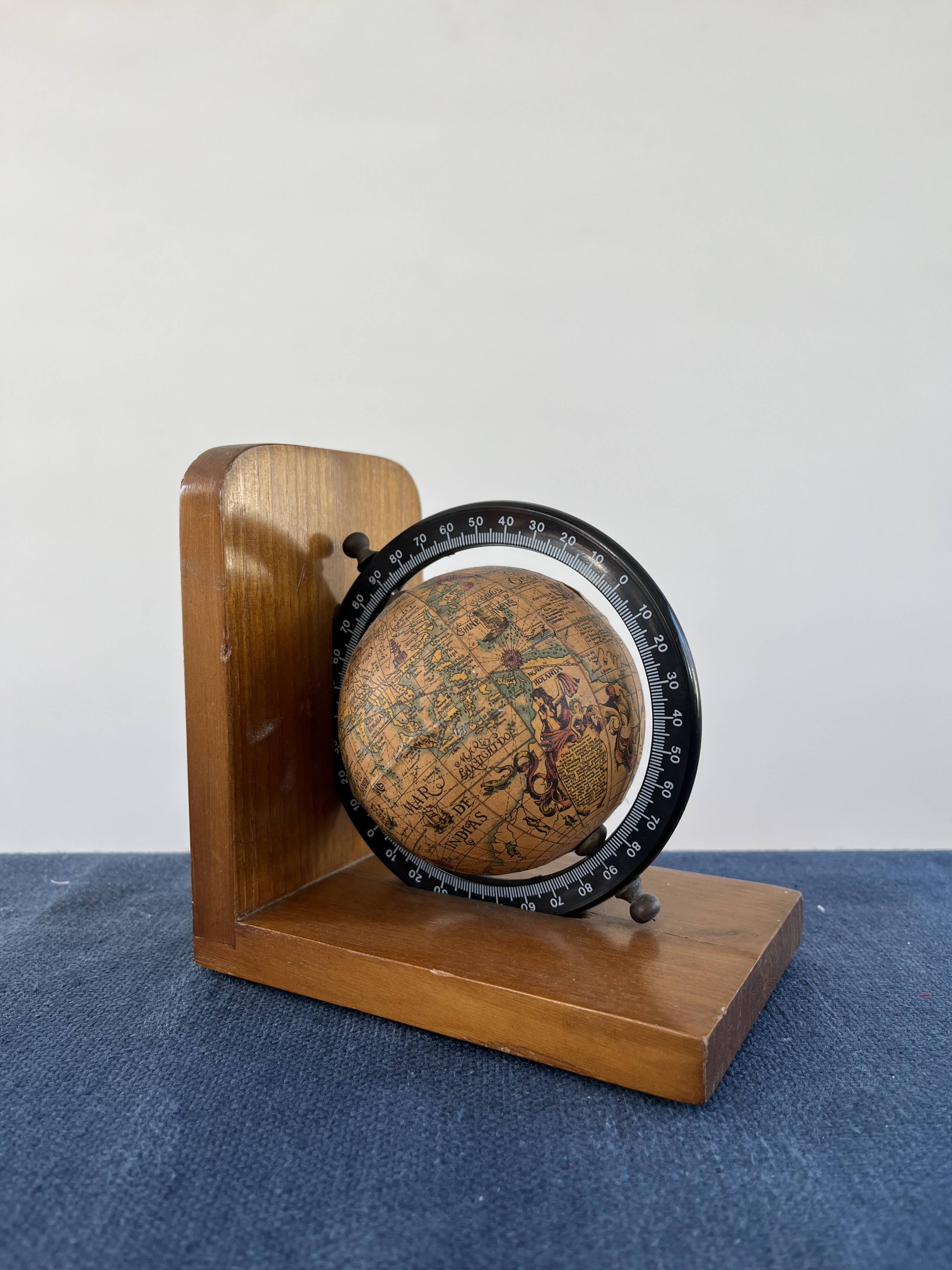 Rotating globe bookends on wooden base