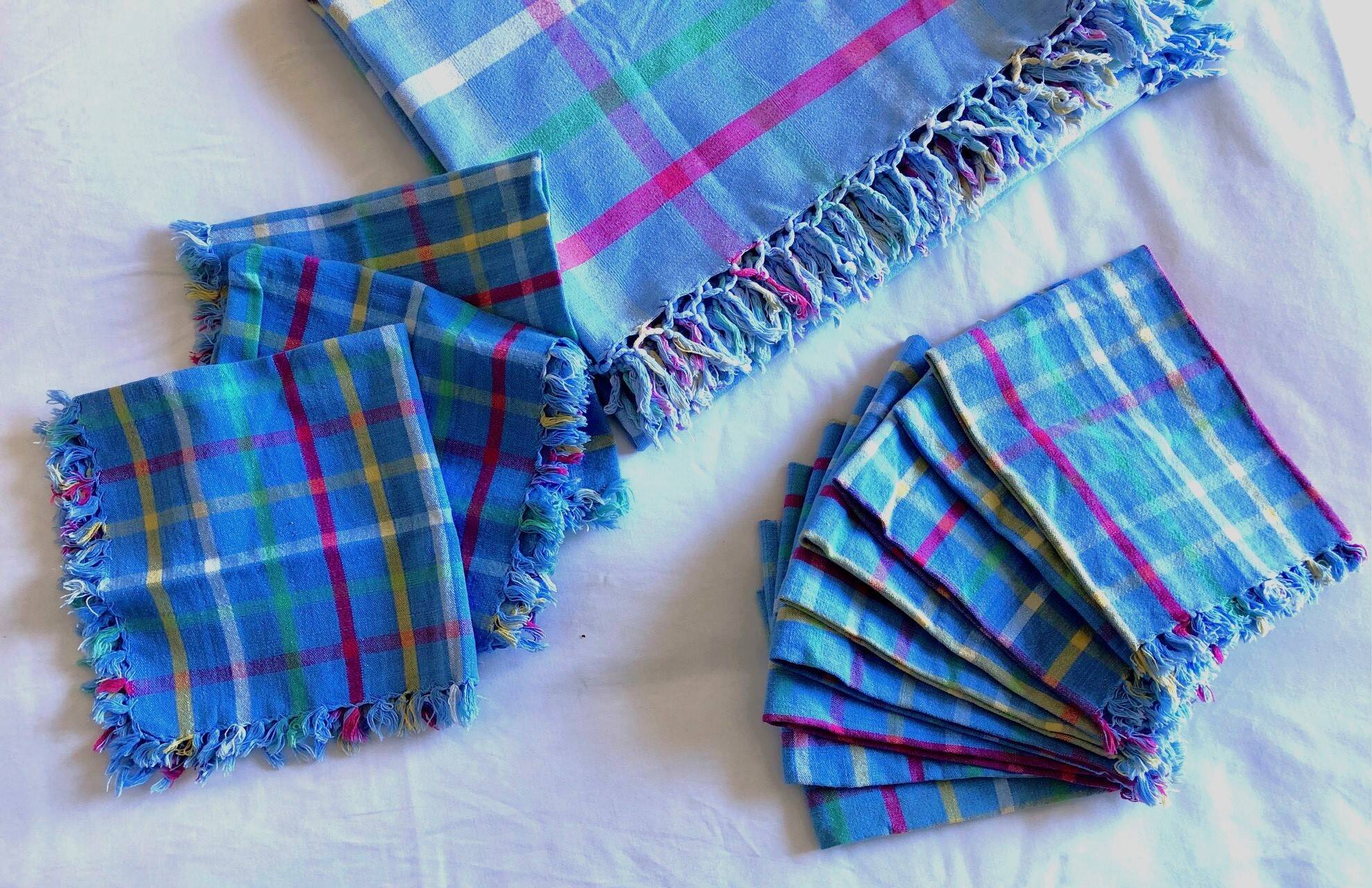 Vintage tablecloth & napkins, blue with multicoloured stripes.