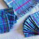 Vintage tablecloth & napkins, blue with multicoloured stripes.
