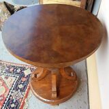 Art Deco side table in brown walnut, round top and scroll legs, France 1930s.