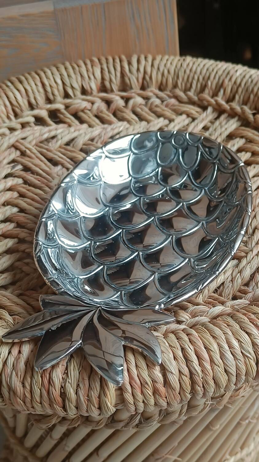 Silver-plated metal tray in the shape of a pineapple.