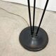 Three-light floor lamp in black lacquered metal, circa 1950.