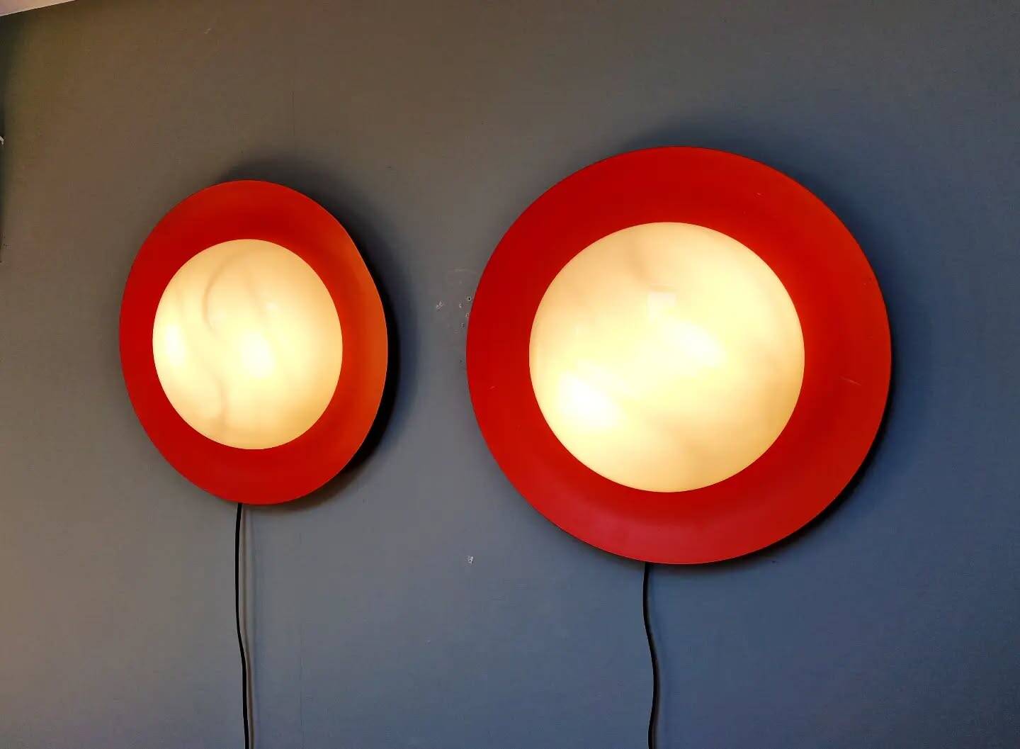Pair of XXL Space Age wall sconces, orange lacquered metal and opaline, 1960.