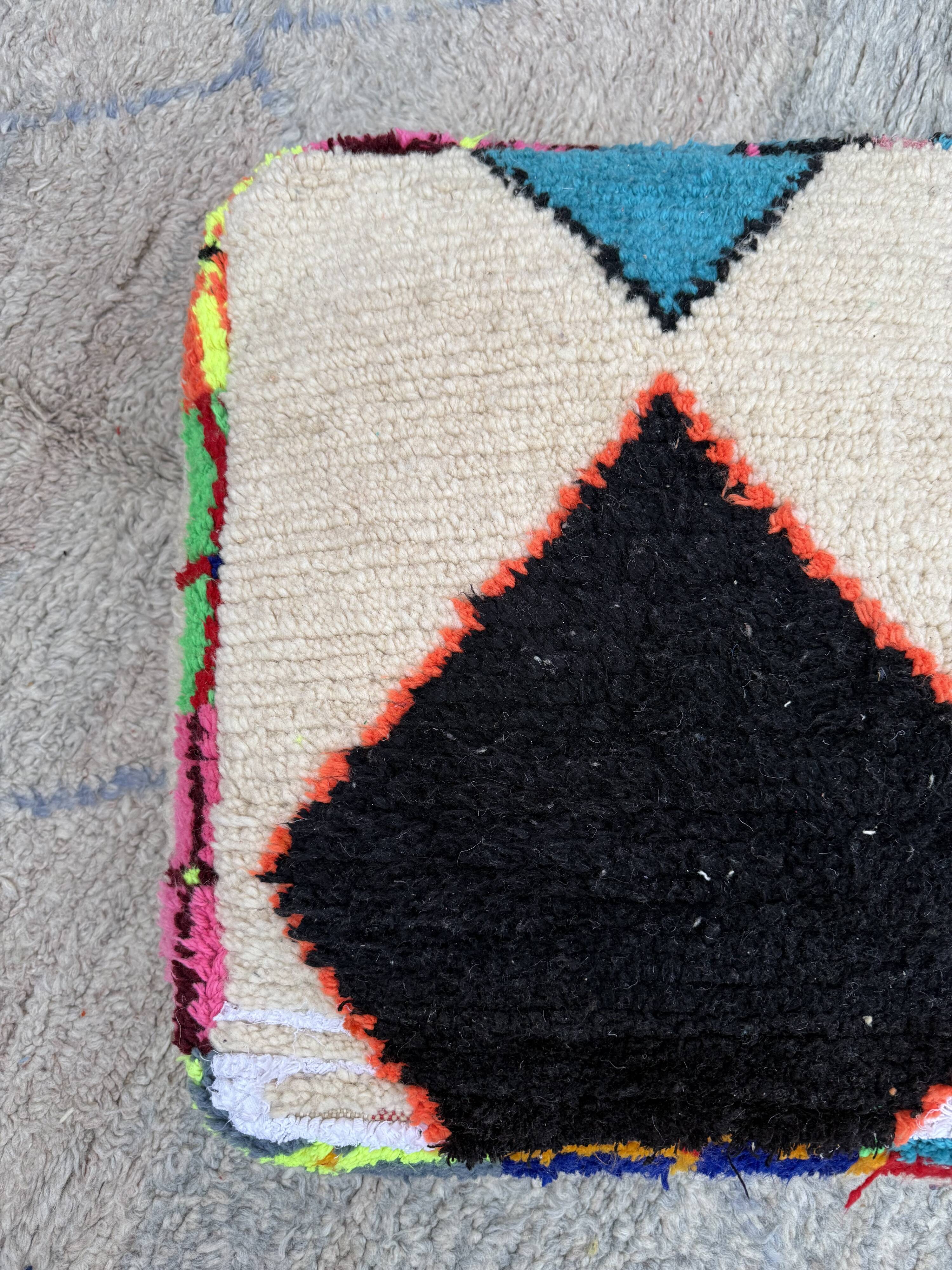 Berber floor pouf: Handwoven Moroccan wool cushion.
