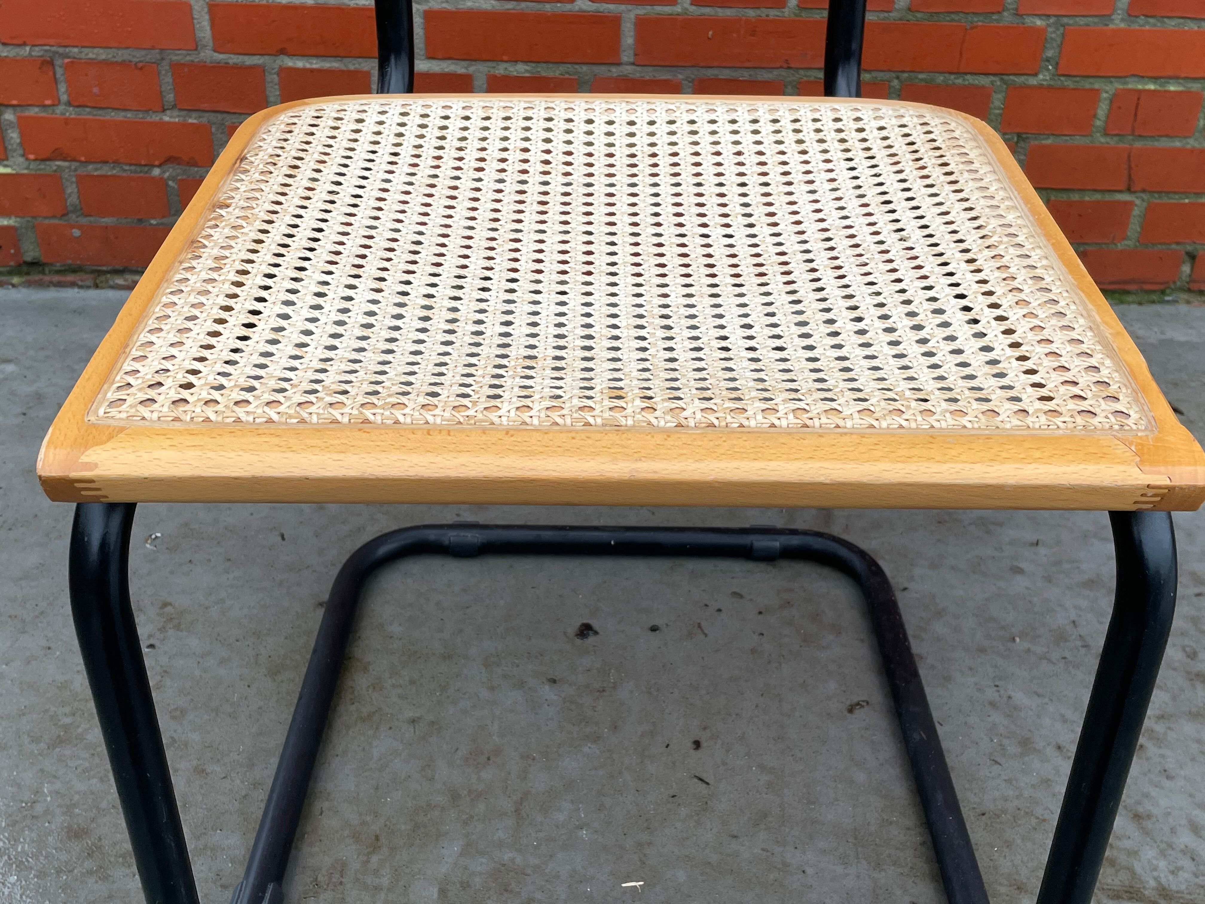 Cesca model chair designed by Marcel Breuer with black-framed armrests