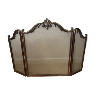 Copper-colored metal fireplace firewall