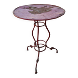 Vintage red cast iron bistro table (1950s) — round metal top, tripod base.