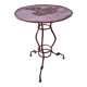 Vintage red cast iron bistro table (1950s) — round metal top, tripod base.