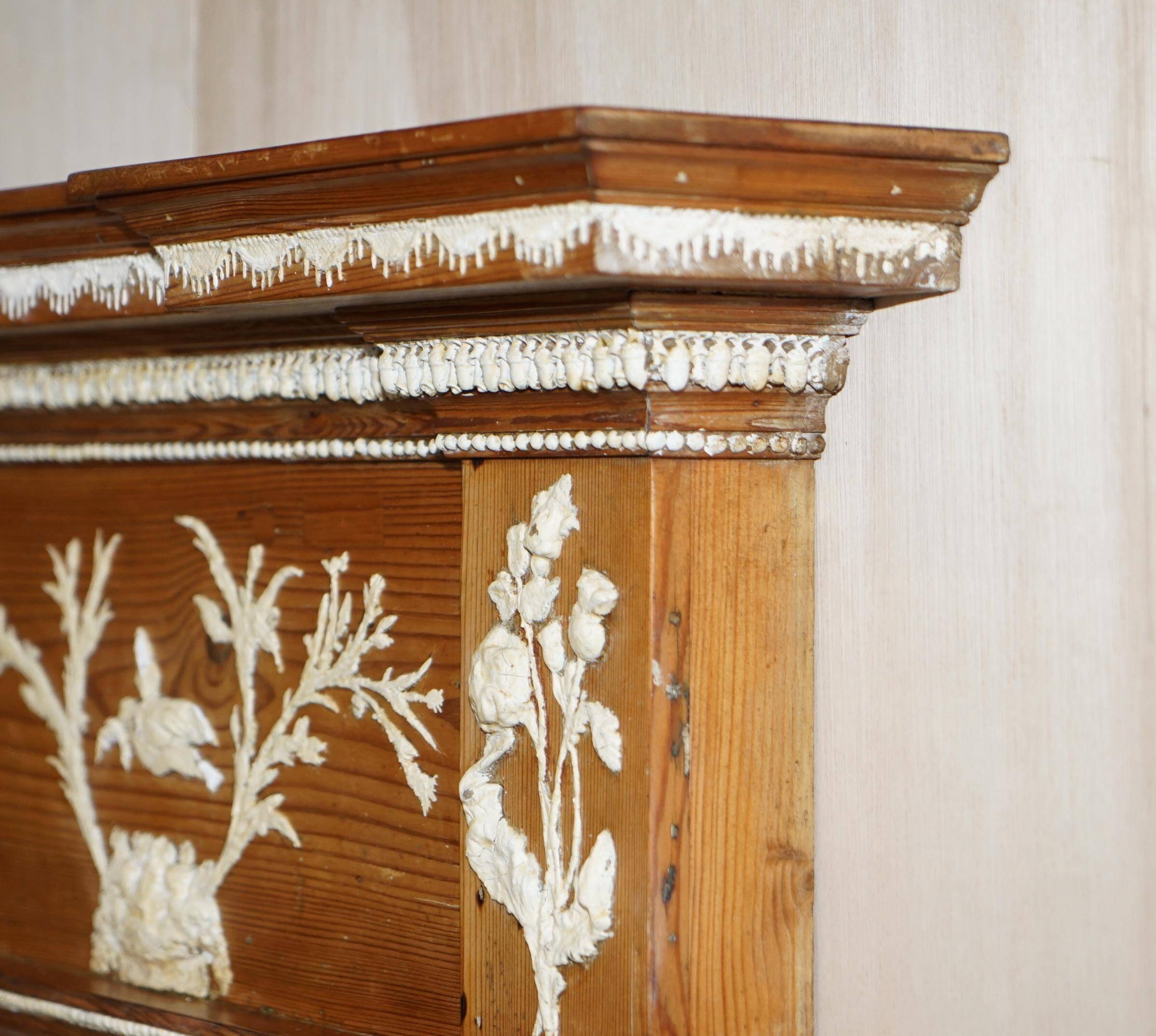Victorian antique fireplace in tarred pine and sculpted gesso.