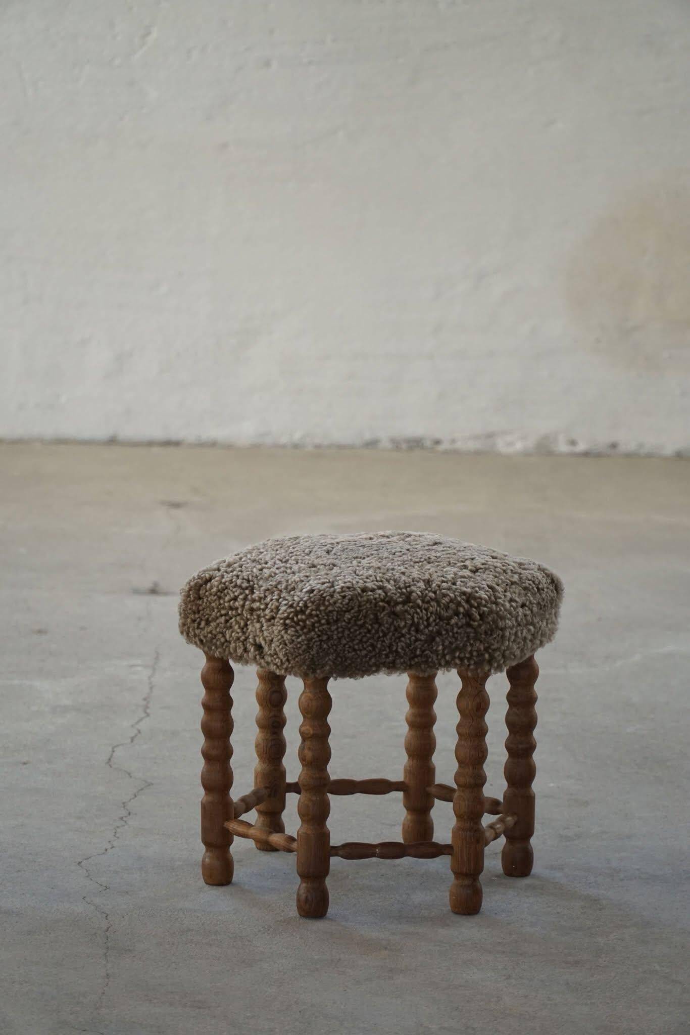 A hexagonal oak stool, seat refurbished in lambswool, Danish design from the 1950s.