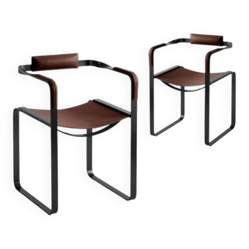 Pair of brown Wanderlust armchairs with black metal elements.