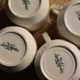 A set of 4 Sarreguemines ecru and gold earthenware cups