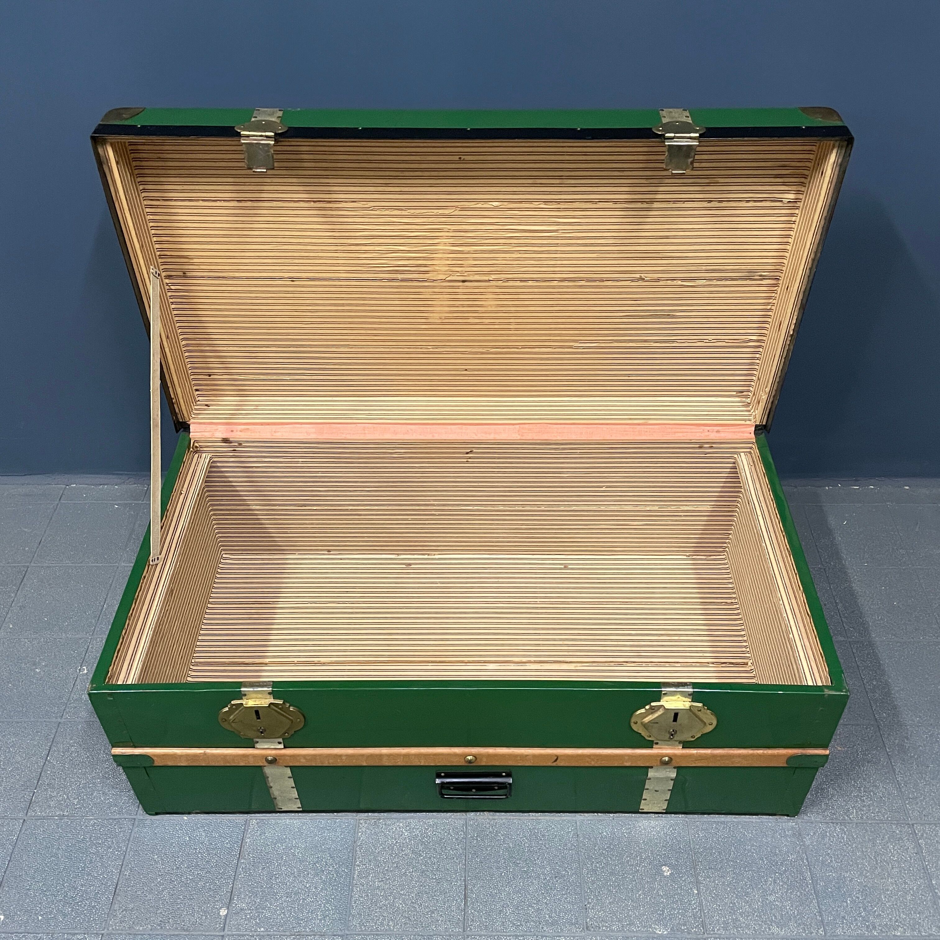 Green metal trunk with wooden sleds