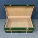 Green metal trunk with wooden sleds