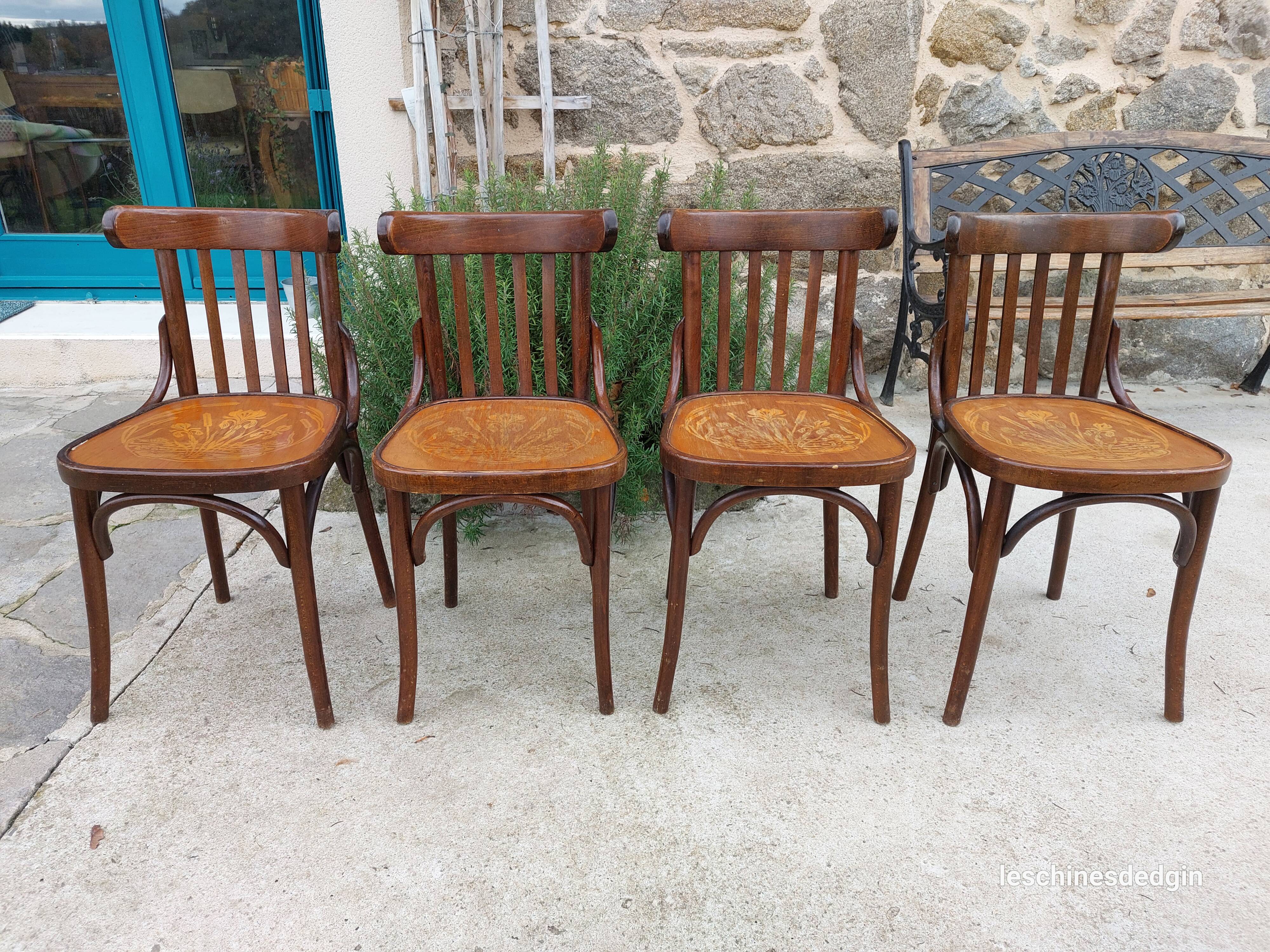 4 bentwood bistro chairs with a pattern on the seat