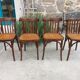 4 bentwood bistro chairs with a pattern on the seat