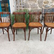 4 bentwood bistro chairs with a pattern on the seat