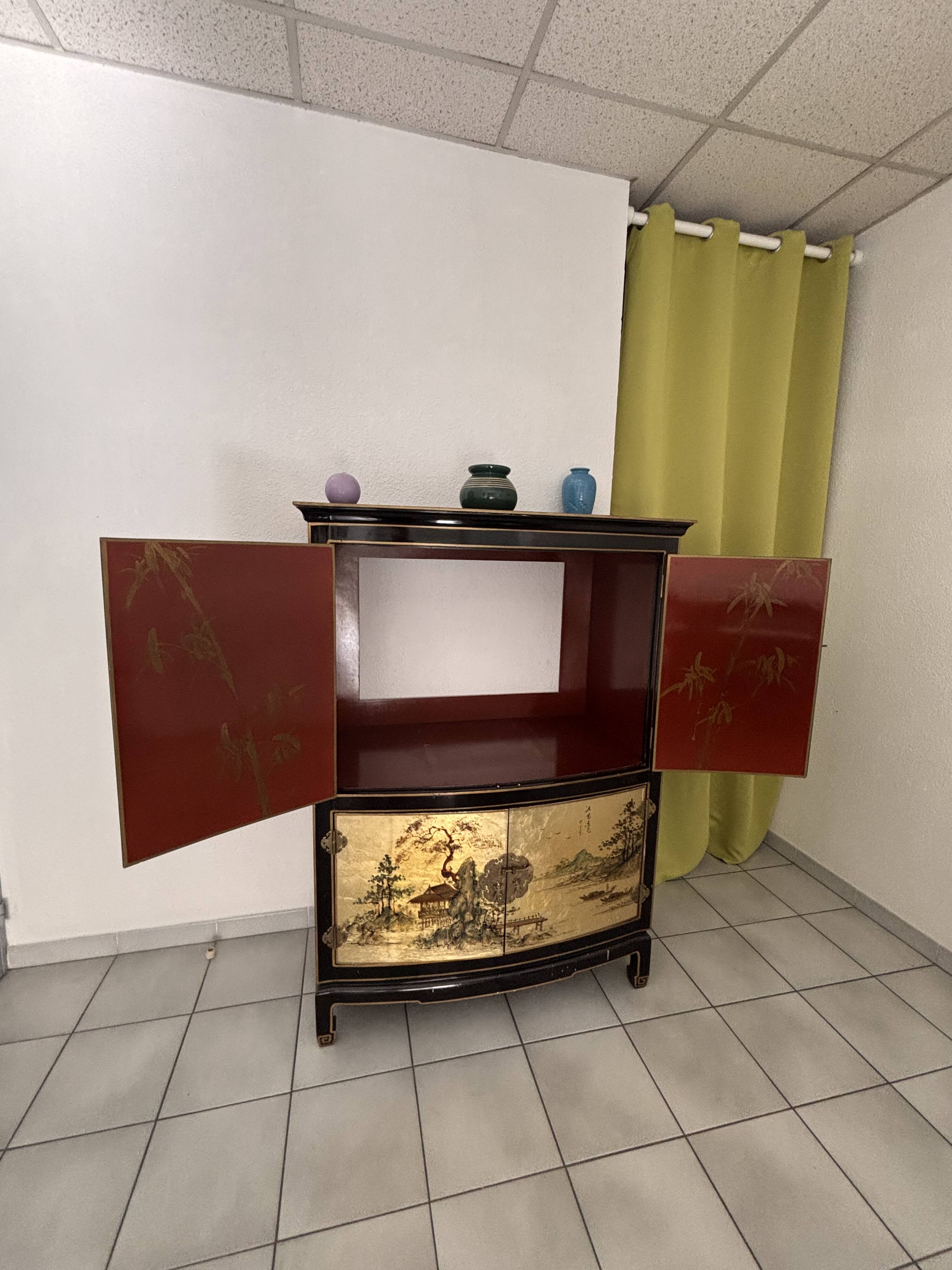 Curved bar cabinet inspired by Chinese design, black lacquer and red interior.