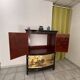 Curved bar cabinet inspired by Chinese design, black lacquer and red interior.