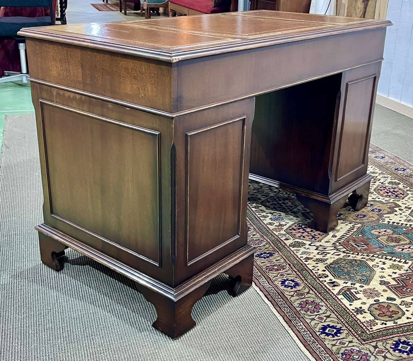 English mahogany pedestal desk with leather top from the 1950s
