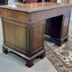 English mahogany pedestal desk with leather top from the 1950s