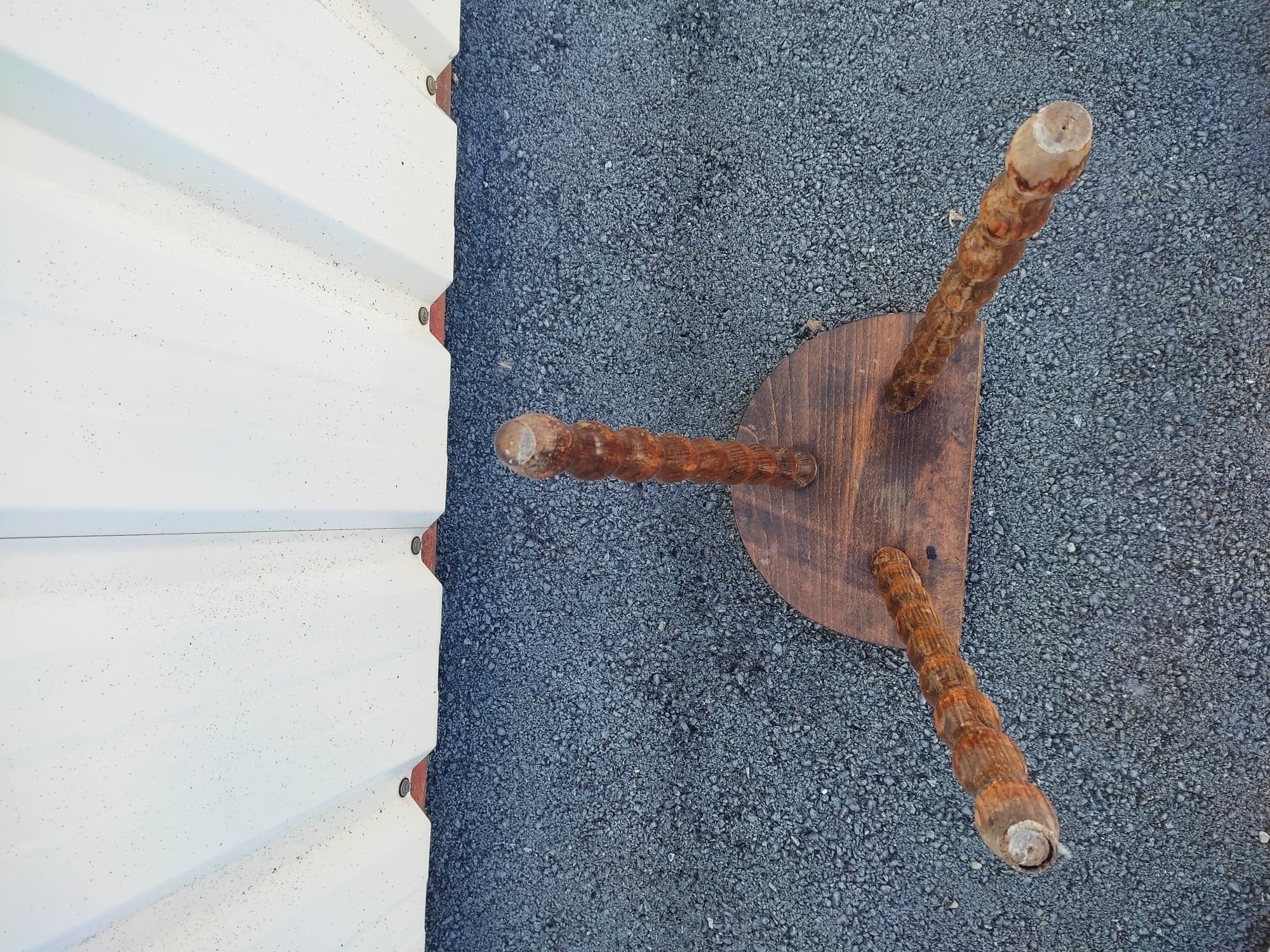 Pretty wooden stool with half moon seat and turned wooden tripod base