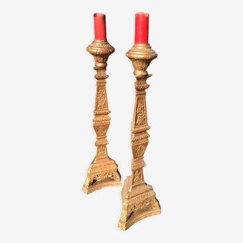 Pair of torchieres in gilded wood and richly carved