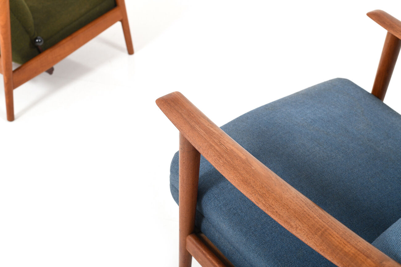 Pair of mid century Danish reclining lounge chairs in teak