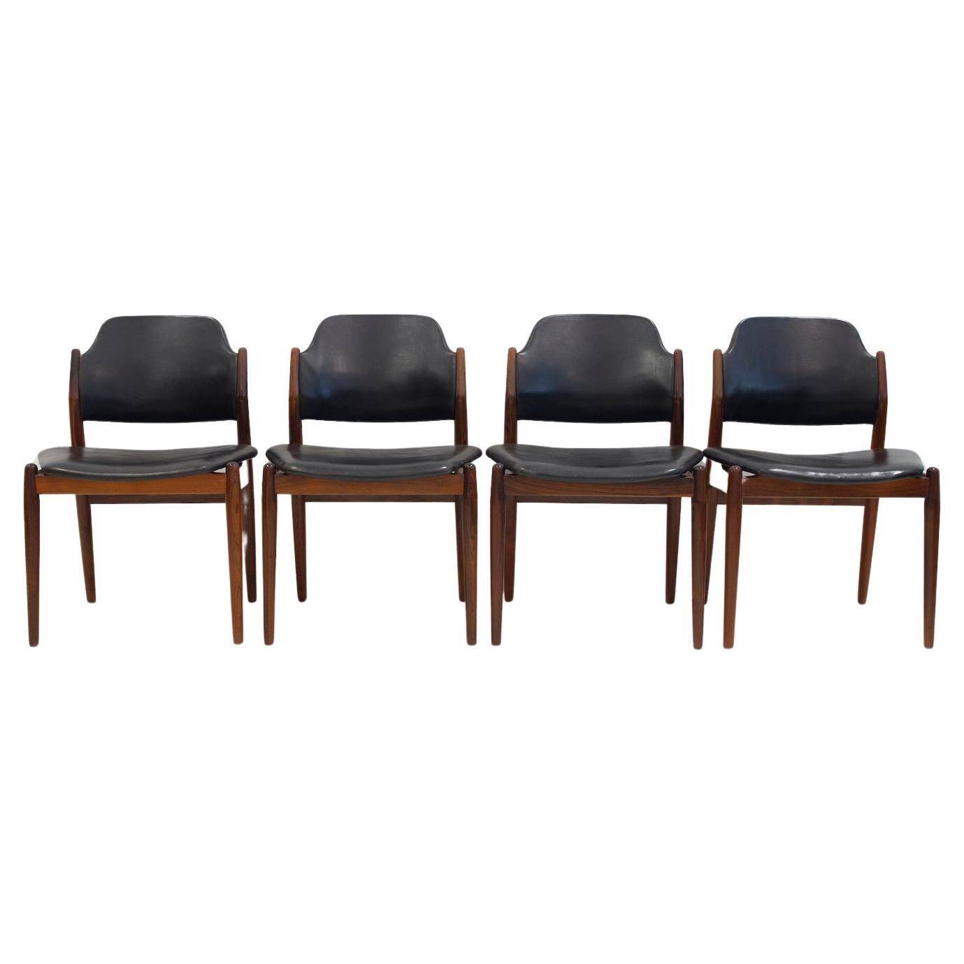 Set of four Arne Vodder chairs in hardwood and black leather.