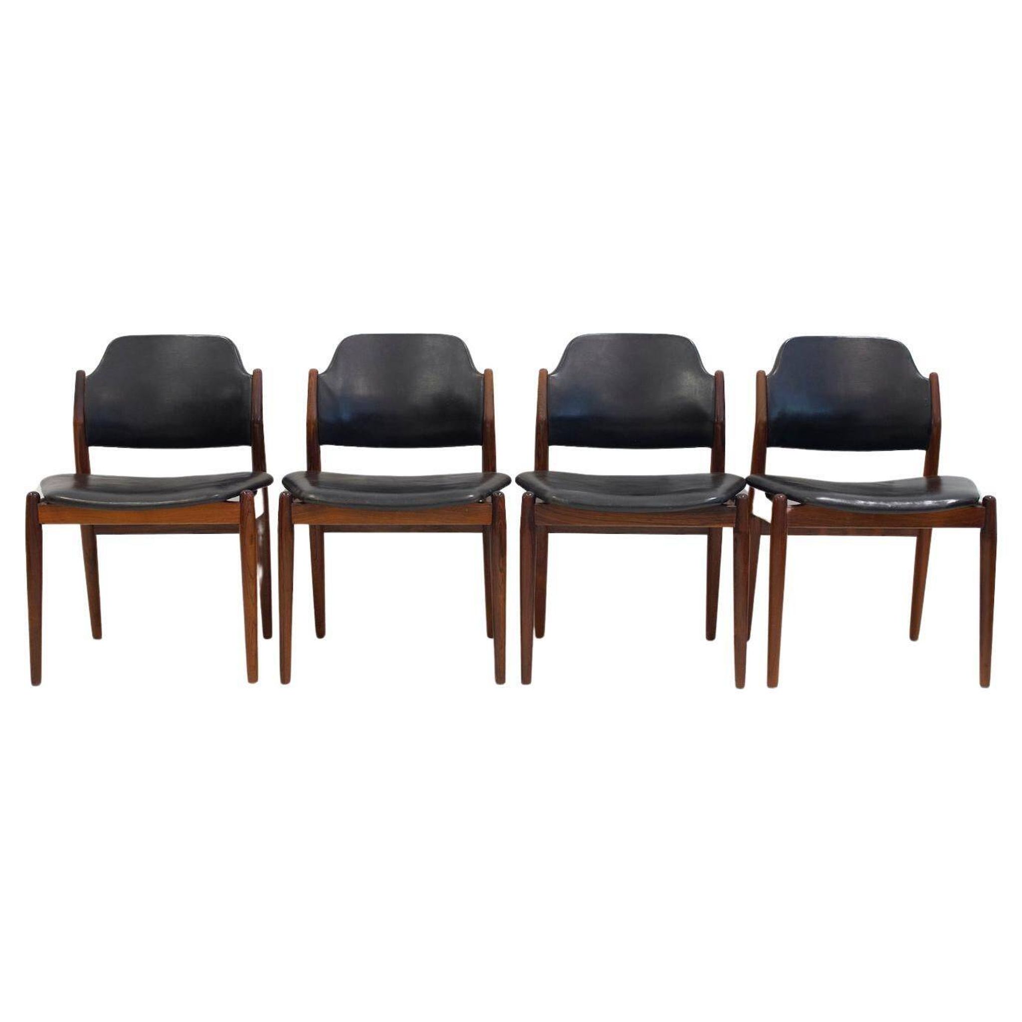 Set of four Arne Vodder chairs in hardwood and black leather.