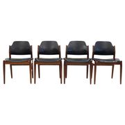 Set of four Arne Vodder chairs in hardwood and black leather.