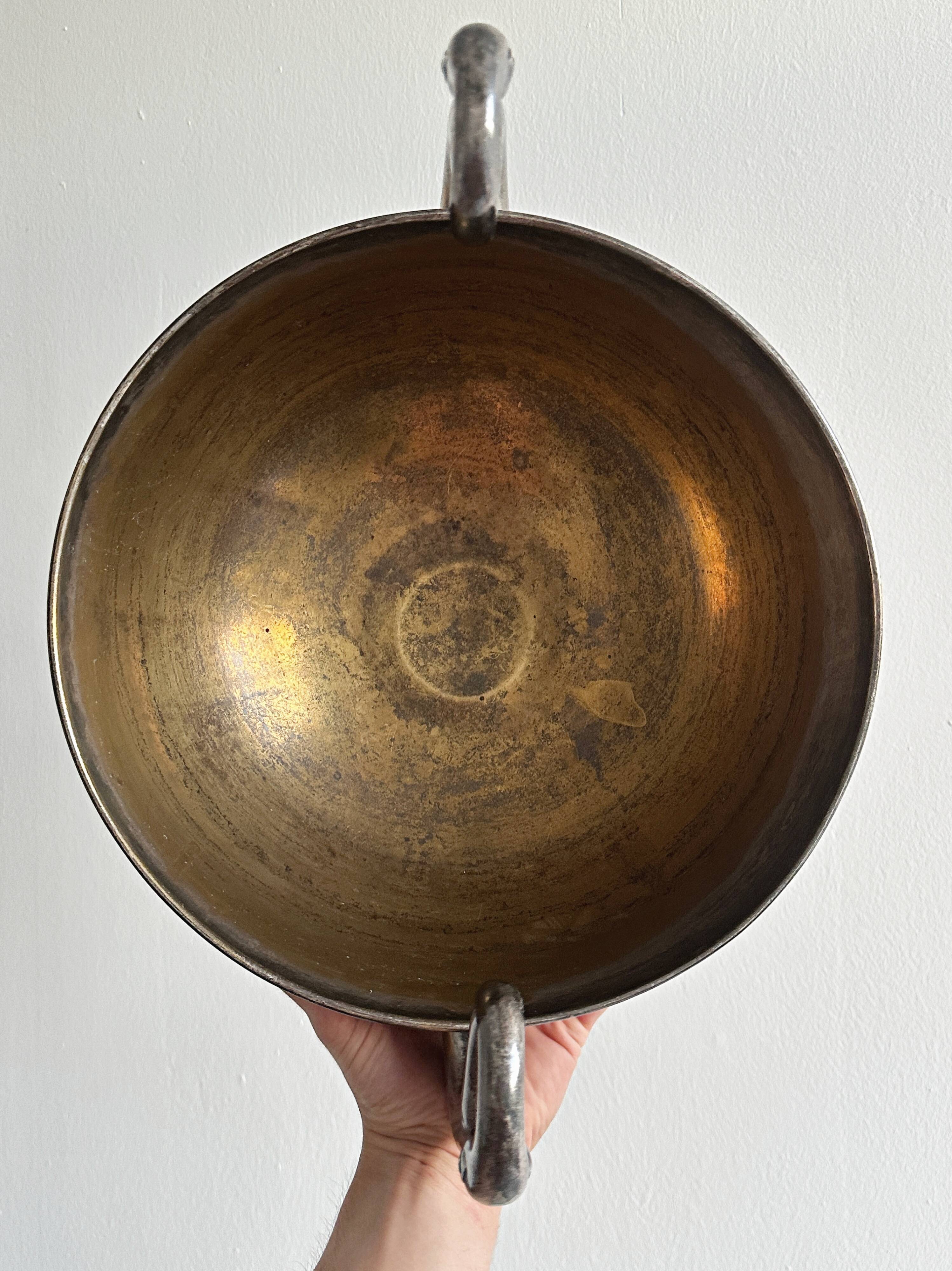 Large champagne bucket with patinated metal swan handles.