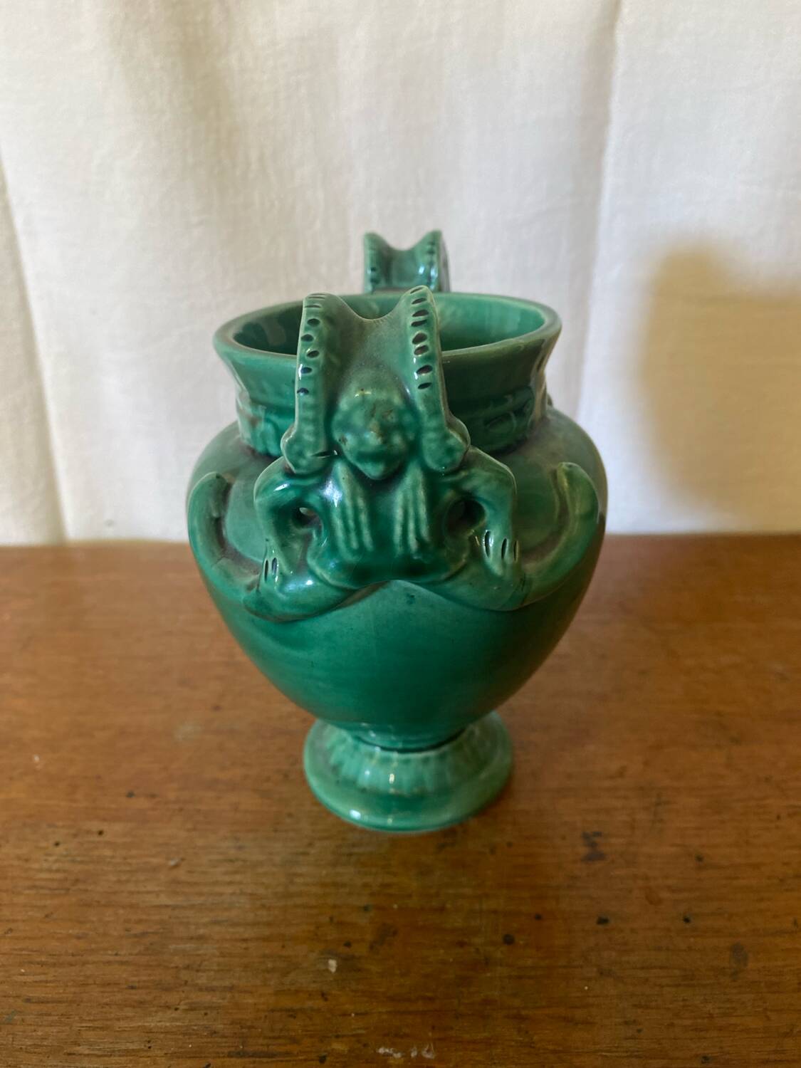 Antique green ceramic vase with handles