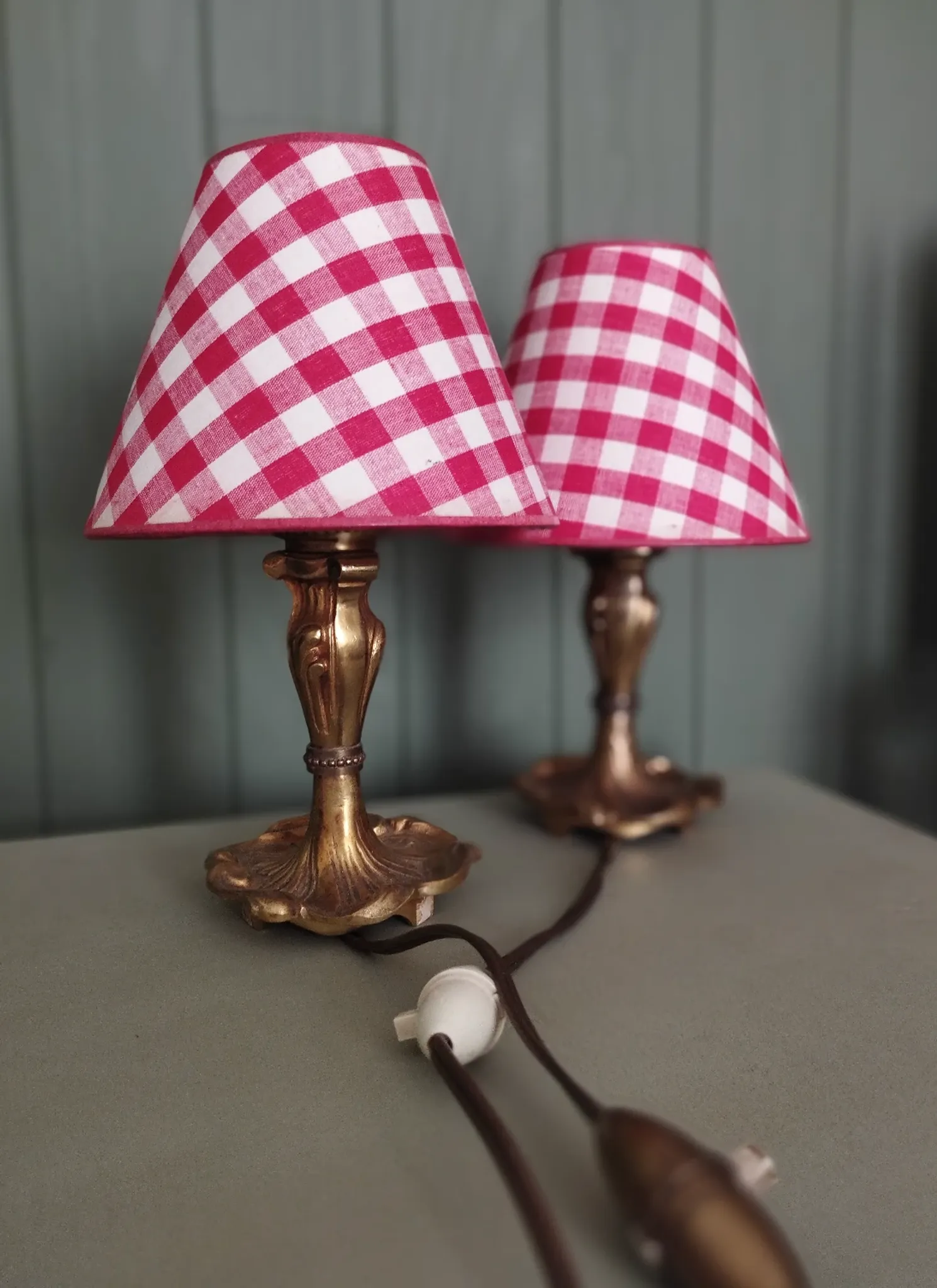 Pair of small lamps in gilded bronze by Petitot and red gingham lampshades.