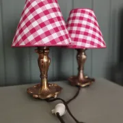 Pair of small lamps in gilded bronze by Petitot and red gingham lampshades.
