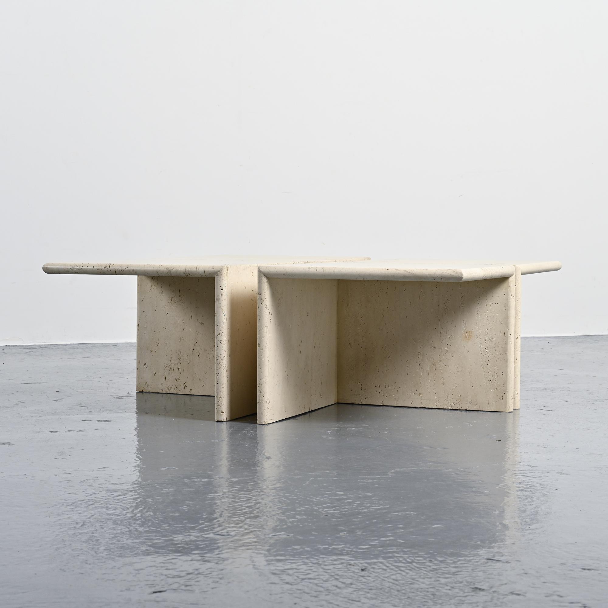 Set of four side tables in travertine, Italy, 1970s.