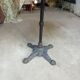 Bistro table with a cast iron base and a wooden top.