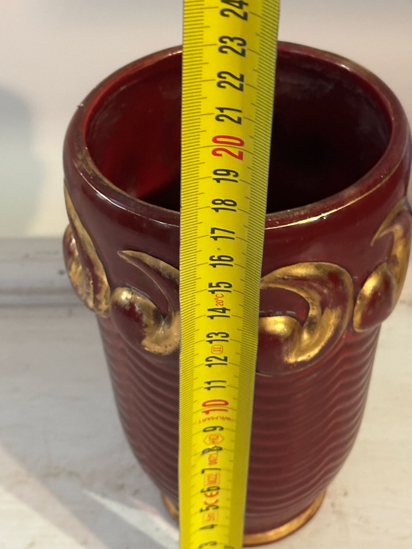 Mid-century relief vase in ruby red enhanced with gilding.