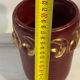 Mid-century relief vase in ruby red enhanced with gilding.