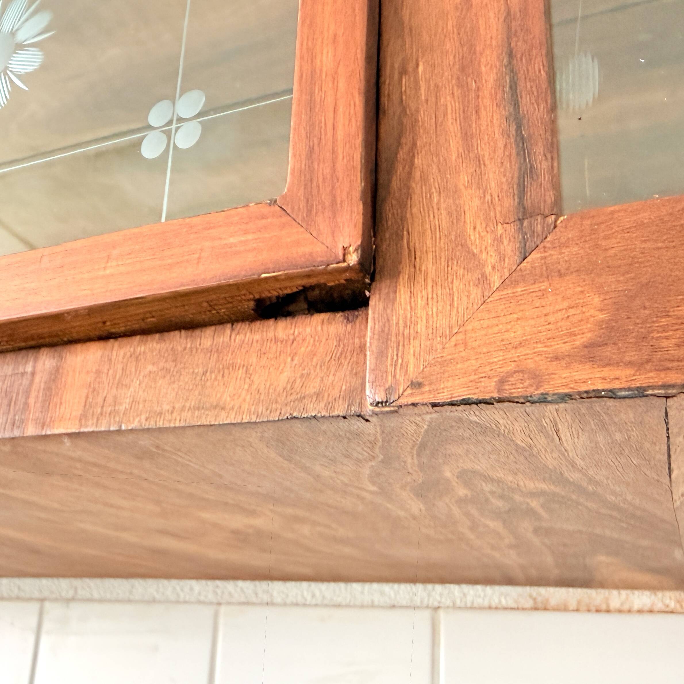 Art Deco-style wall-mounted display cabinet with floral engraving