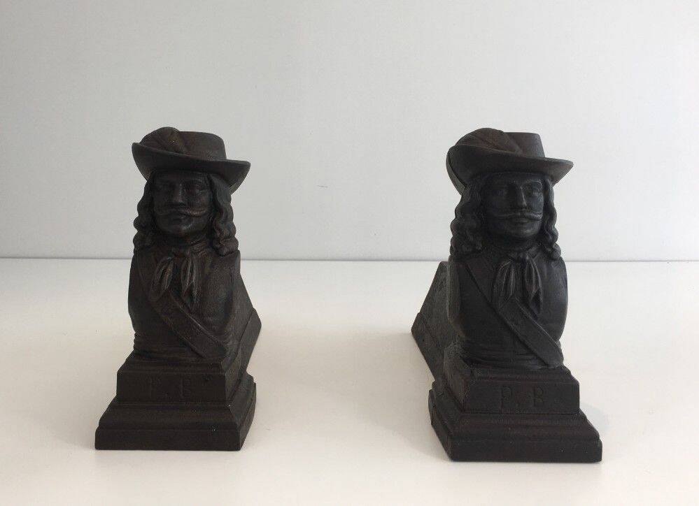 Pair of cast iron andirons in the likeness of a musketeer