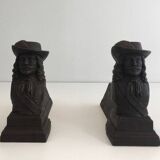Pair of cast iron andirons in the likeness of a musketeer