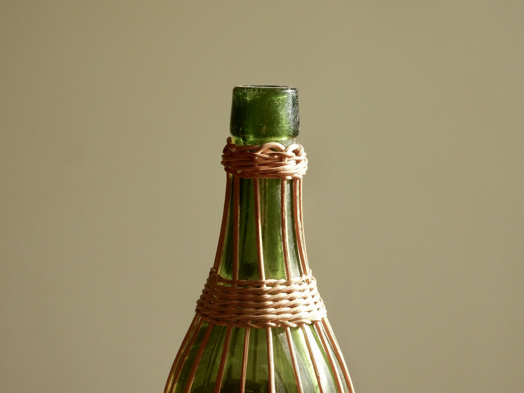 Glass bottle covered with wicker, France of the 60