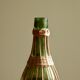 Glass bottle covered with wicker, France of the 60