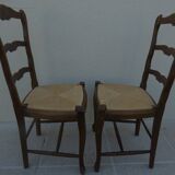 2 stylish solid wood chairs with high backs and straw seats