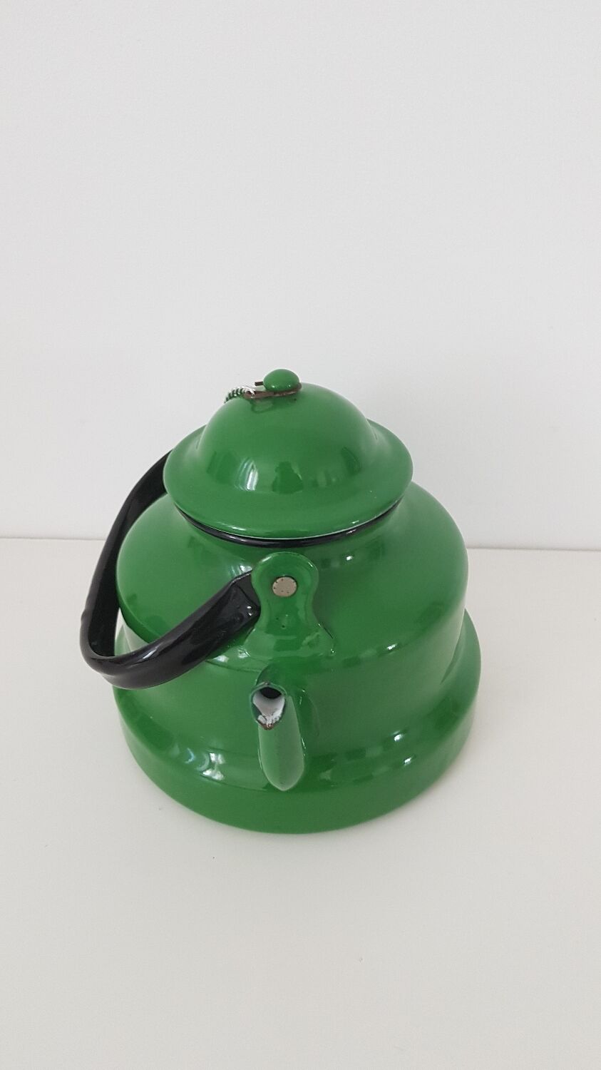 Old green kettle in enamelled metal