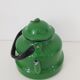 Old green kettle in enamelled metal