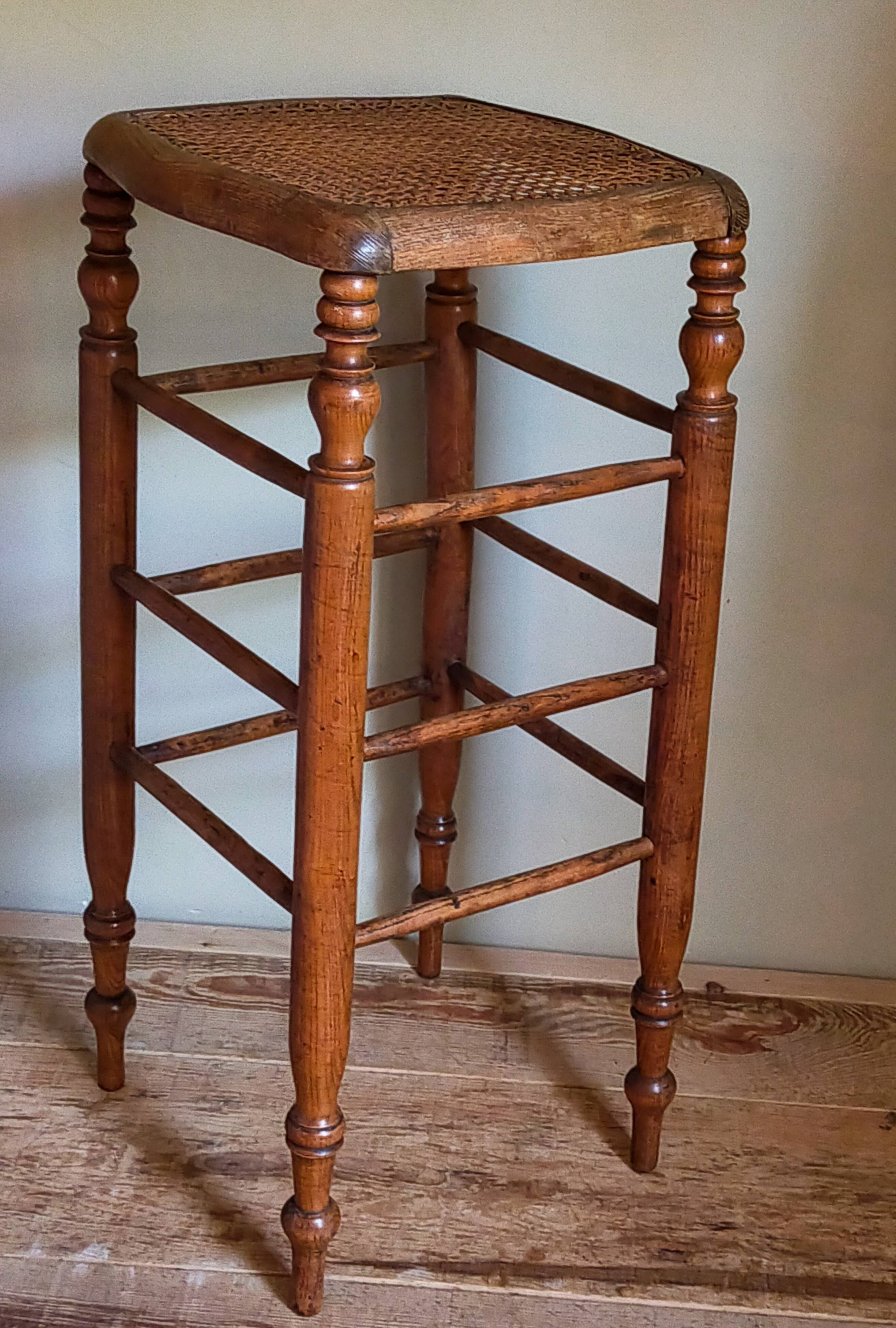 Antique stool with cane and turned wood